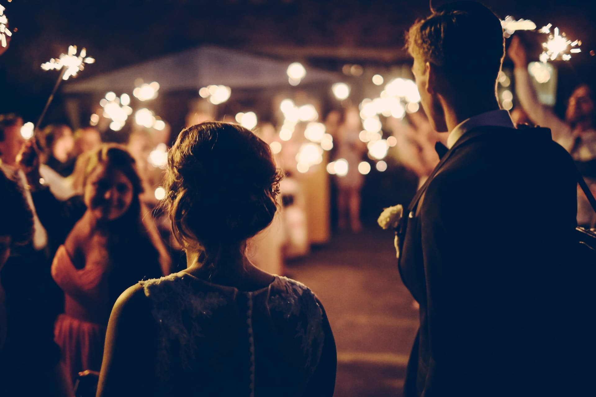 A UK wedding couple walking through a manor garden
